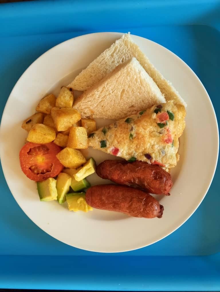 Breakfast plate with omelette, sausages, potatoes and toast