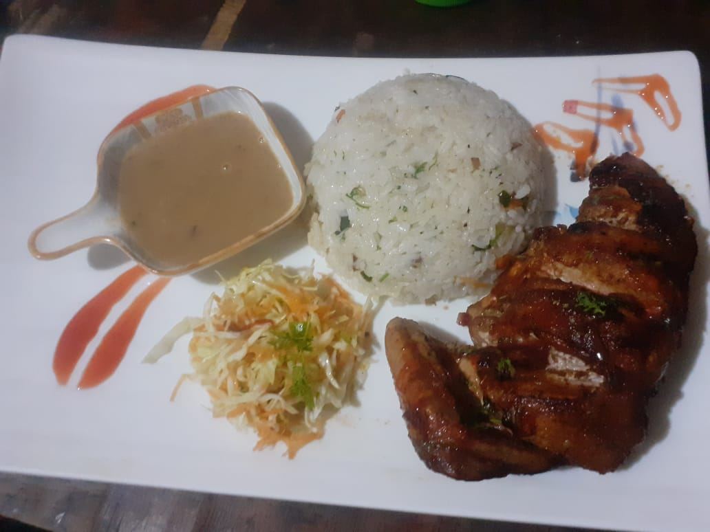 Grilled chicken with pilau rice, salad and gravy